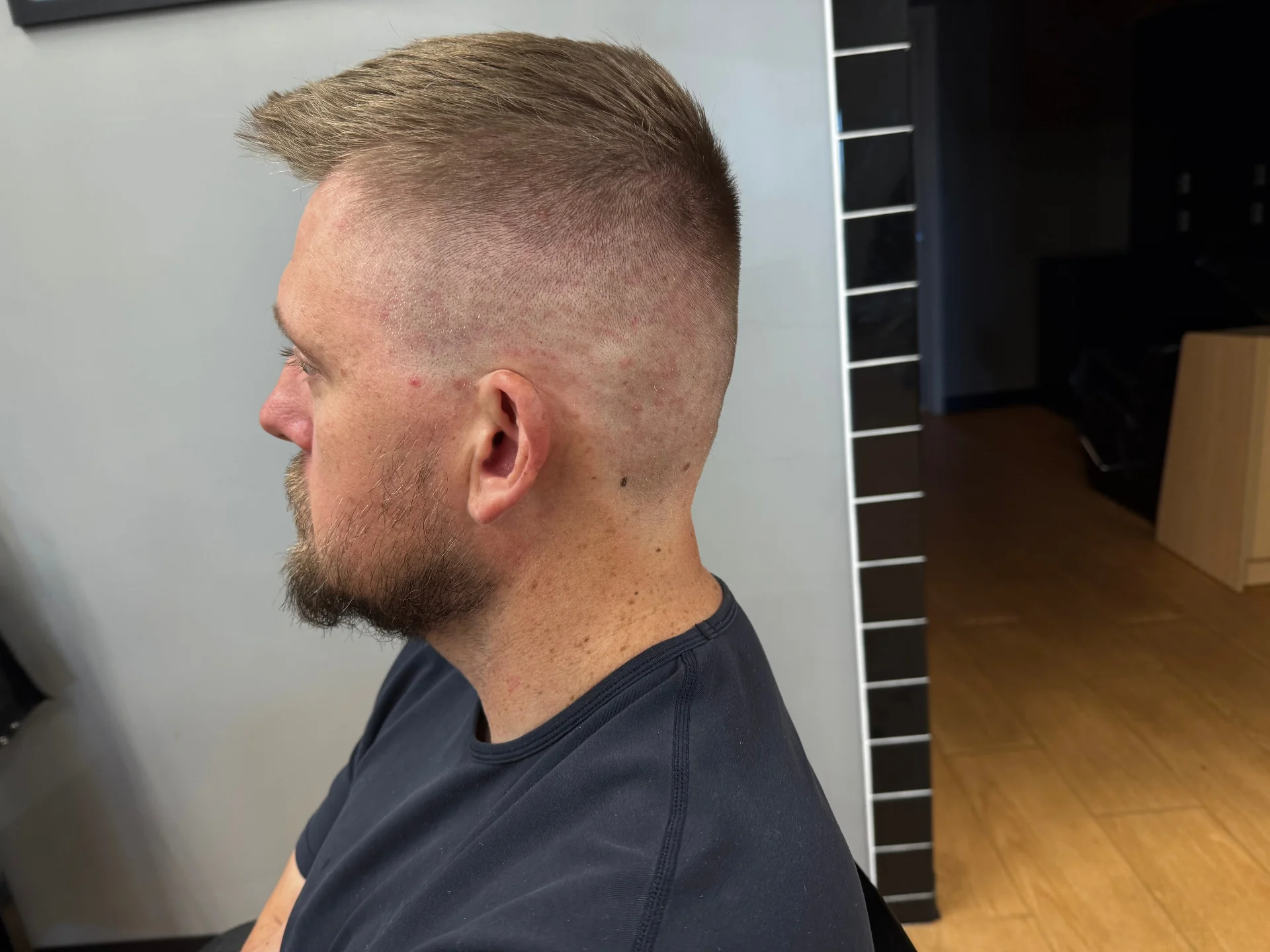 Client after fresh fade and styled top by Hair Ambition mobile barber in Goodyear, AZ